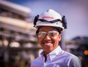 Veolia employee smiling wearing safety equipment